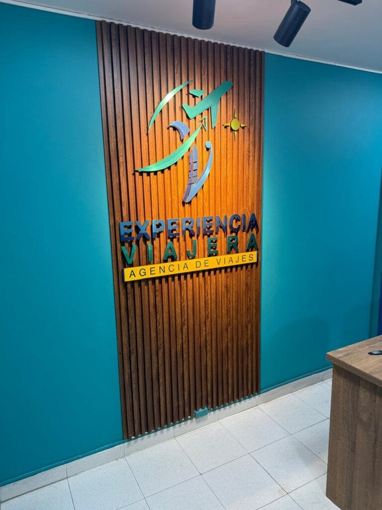 Logo Experiencia viajera en pared oficina.